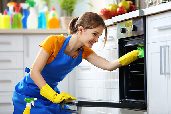 Person Cleaning Oven